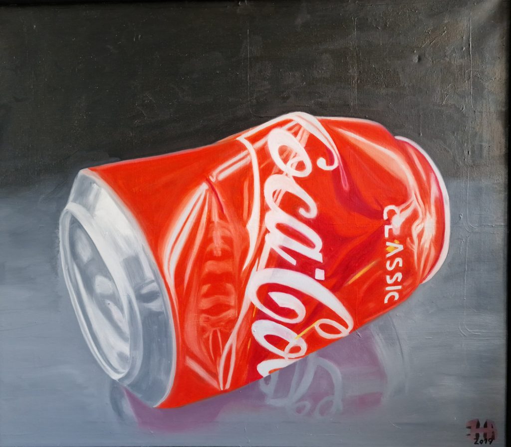 Crushed cola can on shinning surface by Jesper Hansen